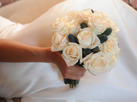 10 cream roses and echinops 
